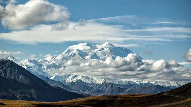 Glacier-carved valley under a wide Alaskan sky