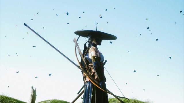 Silhouette with katana near a torii at dusk