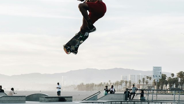 Skater cruising through the city at golden hour